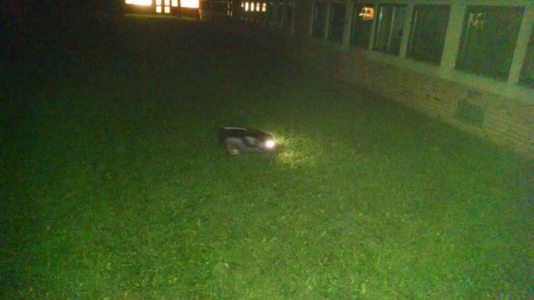 automatic lawnmower at night in HFL High School courtyard